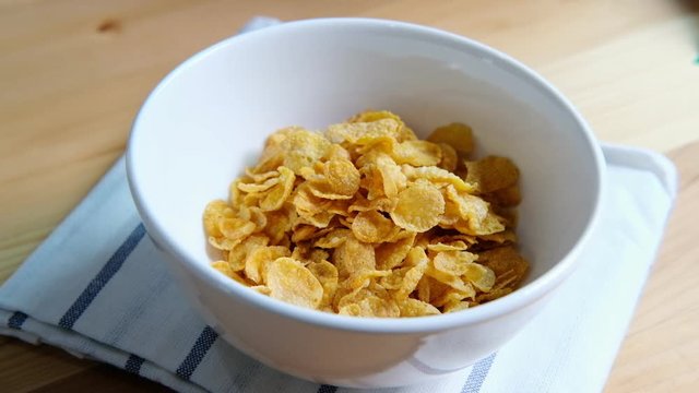 Healthy breakfast with corn flakes and milk on wooden table