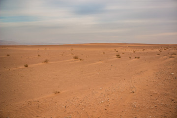 desert calm peaceful idyllic scenery landscape photography from Saudi Arabia wilderness dangerous sandy wastelands with horizon view and gray cloudy sky