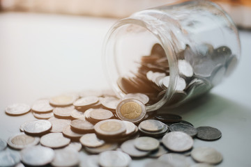 Pour the coins out of the glass jar.