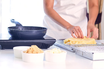 Womon are making in the kitchen.