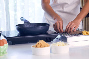Womon are making in the kitchen.