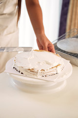 Womon are making in the kitchen.