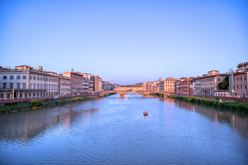 Obraz premium June 6, 2019 - Florence, Italy - A view of the Arno River and the Ponte Vecchio in Florence, Italy.