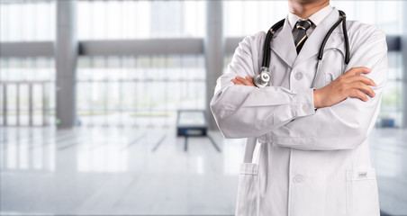 young doctor with hospital background