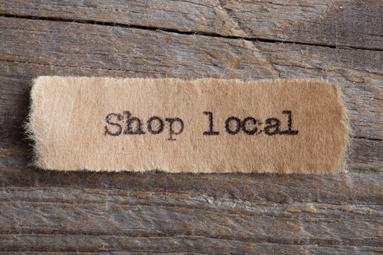 Shop local word on a piece of paper close up, business creative motivation concept