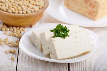 Soy Bean curd tofu on clay dish closeup. Non-dairy alternative substitute for cheese
