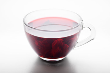 Hibiscus Tea cup with petals inside on white background