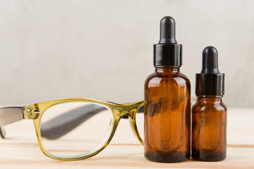 eyesight care concept eye drops and eyeglasses close up