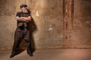 Portrait of bearded hipster with tattooe on his arms.