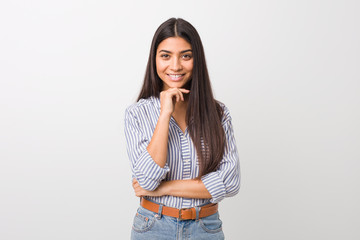 Young pretty arab woman smiling happy and confident, touching chin with hand.