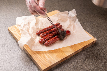 Food concept - Traditional horse meat sausage covered with sauce