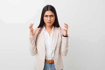 Young business arab woman isolated against a white background screaming with rage.