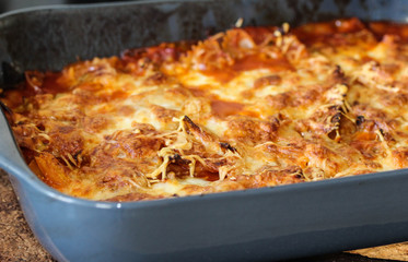 baking self made Italian lasagne, with mozzarella in the oven in the kitchen