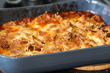 baking self made Italian lasagne, with mozzarella in the oven in the kitchen