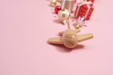 wooden children's plane on a pink background