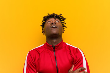 Fototapeta premium Young fitness black man tired of a repetitive task.