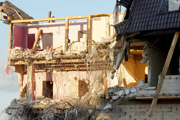 The destruction of a multi-storey building close-up. Floors and walls spread, reinforcement...