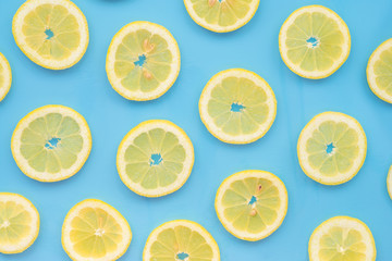 Lemon slices scattered on a blue background