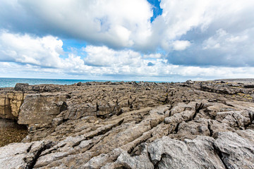 Spectacular limestone landscape with sea the sea in the background at Bothar nA hAillite, Geopark...