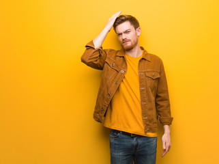 Young redhead man worried and overwhelmed