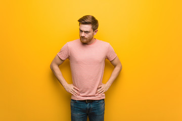 Young redhead man scolding someone very angry
