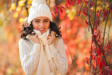 Young beautiful woman at autumn background. Portrait of attractive young girl outdoors