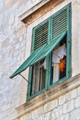 Fototapeta na wymiar Window with shutters, Dubrovnik, Croatia
