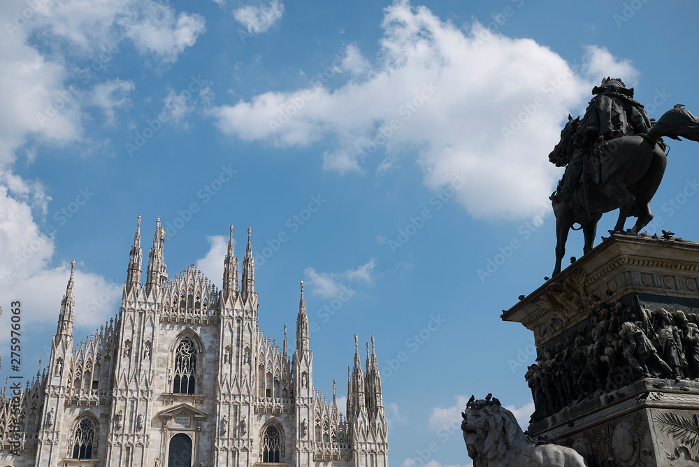 Wall mural Milan, Italy - April 09 2019: View of Vittorio Emanuele equestrian monument and Duomo on the foreground