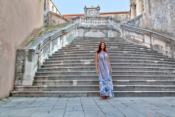 Obraz na płótnie Canvas Beautiful girl on vacation. Croatia, Dubrovnik. Stone stair