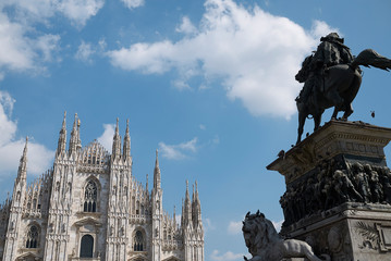 Naklejka na ściany i meble Milan, Italy - April 09 2019: View of Vittorio Emanuele equestrian monument and Duomo on the foreground