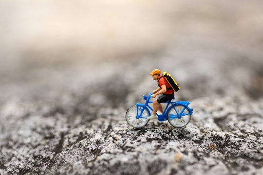 Miniature people : Travelers riding bicycle on the road. Image use for background traveling  business concepts.