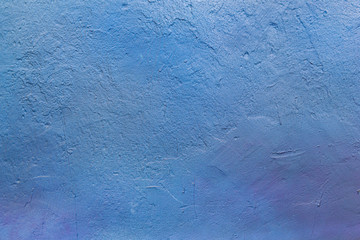 The texture of the concrete wall is blue and purple. Raw plaster wall background