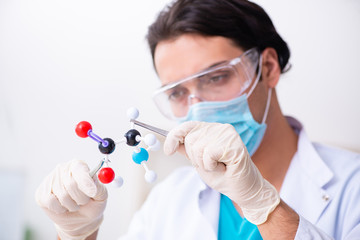 Young male chemist working in the lab 