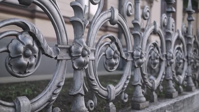 Forged fence close-up slow pan shot.