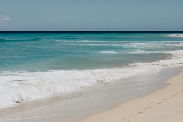 ocean landscape. sand beach and water of blue ocean