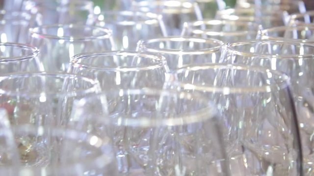 Crystal clear glass goblets shine on the banquet table