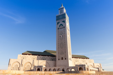 Fototapeta premium Mosque Hasan II in Casablanca, Morocco on a sunny morning. It is one of the biggest mosques in the world with the highest minaret, 210 meters high.