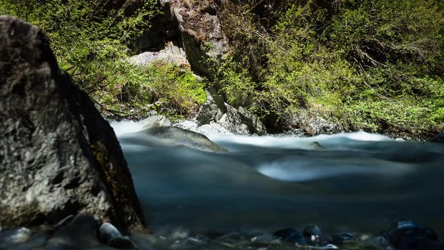 timelapse view of a waterfall and river in the valley of vallorcine from the chemin des diligences near chamonix in the french alps during springtime and the spring melt