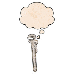 cartoon adjustable wrench and thought bubble in grunge texture pattern style