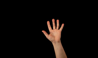The hand of a young man on a black background