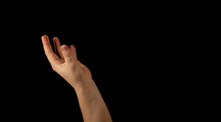 Fototapeta premium The hand of a young man on a black background