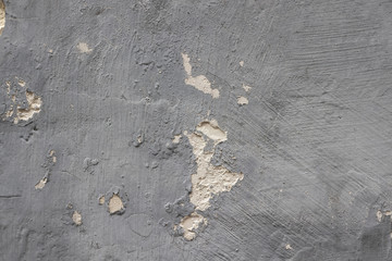 Peeling grey wall, detail of an abandoned and crumbling wall