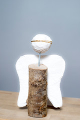 Homemade angel made of plaster and wood with golden wreath