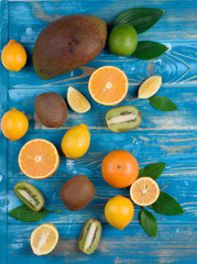 View from above fruits on a wooden board and blue background