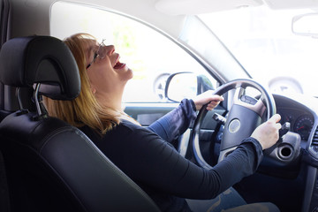 woman in car indoor keeps wheel