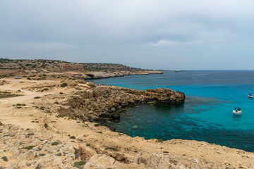 CYPRUS, CAPE CAVO GRECO - MAY 11/2018: Tourists sailed on a motor boat into the blue lagoon for swimming.