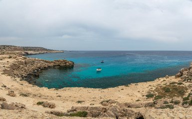 CYPRUS, CAPE CAVO GRECO - MAY 11/2018: Tourists sailed on a motor boat into the blue lagoon for swimming.