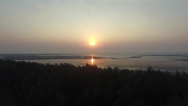 Beautiful view of a Drone Shot of a Setting/Rising Sun alongside the Sea