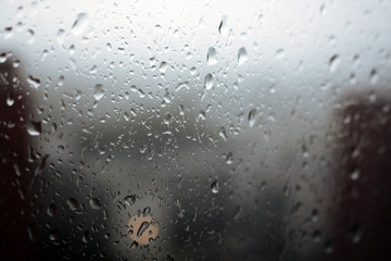 Big raindrops on window glass during storm