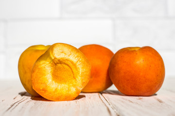 Fresh ripe apricots on a white wooden background. Side view.
